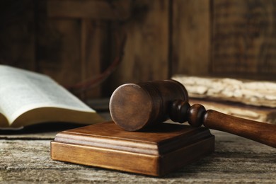 Photo of Judge gavel on old wooden table, closeup