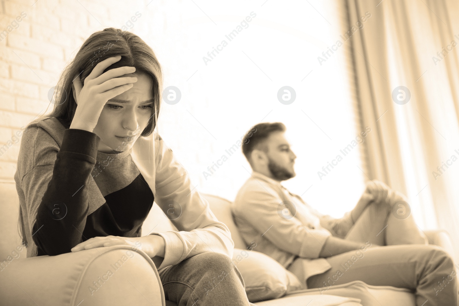 Image of Unhappy young couple with relationship problems at home, focus on woman. Cheating and breakup