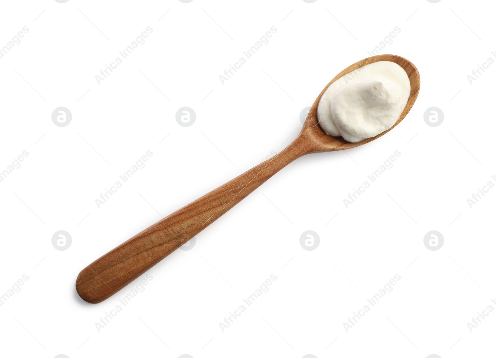 Photo of Sour cream in wooden spoon isolated on white, top view