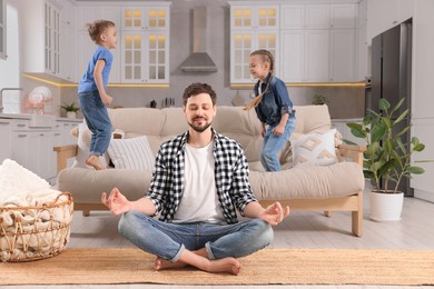 Father meditating while children playing at home