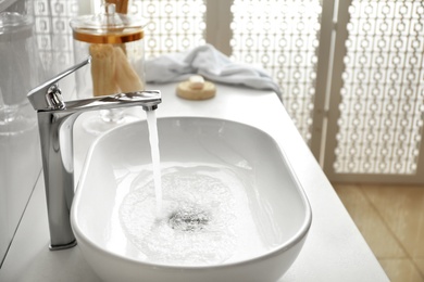 Photo of Stylish white sink in modern bathroom interior