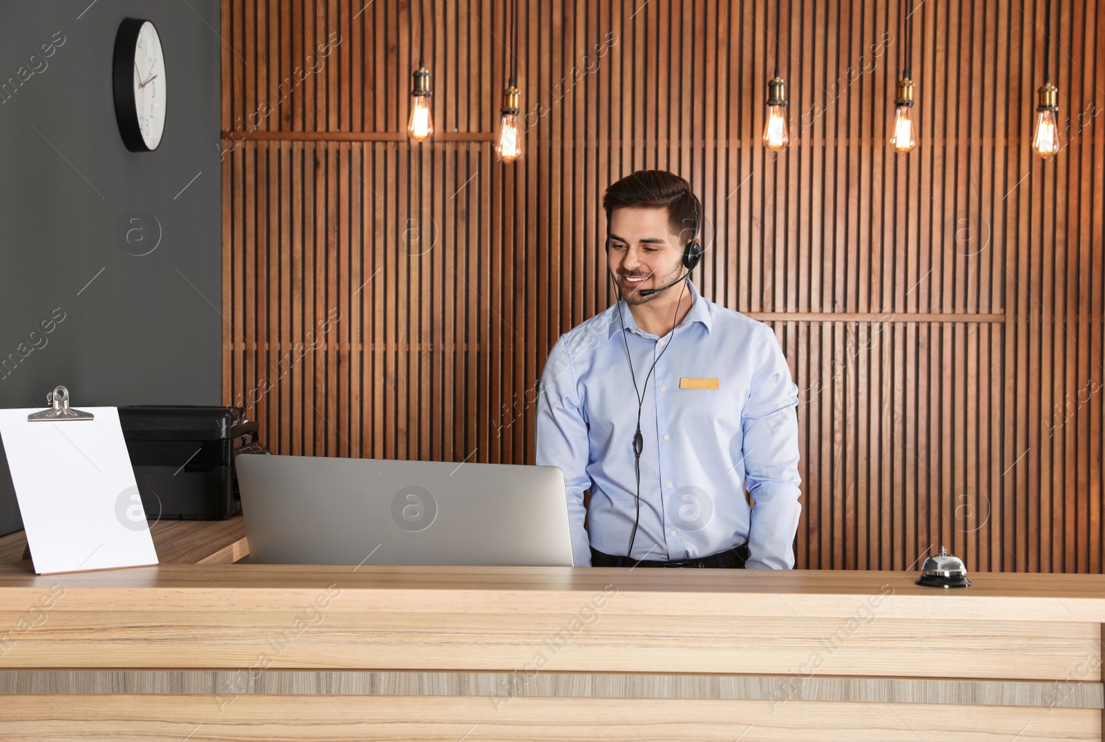 Photo of Portrait of receptionist with headset at desk in lobby