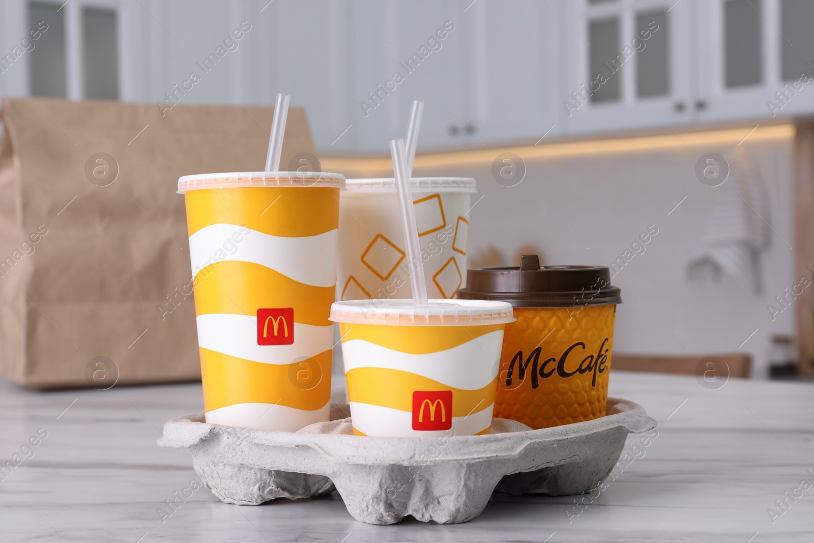 Photo of MYKOLAIV, UKRAINE - AUGUST 12, 2021: Cold and hot McDonald's drinks on marble in kitchen