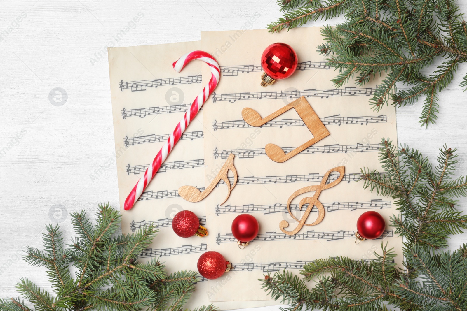 Photo of Composition with music notes and decorations on wooden background, top view
