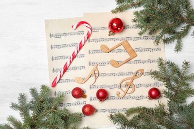 Composition with music notes and decorations on wooden background, top view