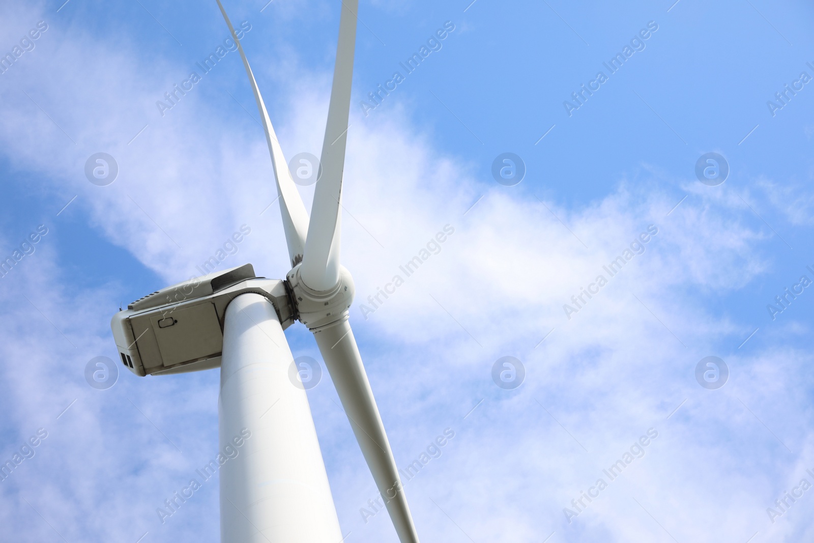 Photo of Wind turbine against beautiful blue sky, low angle view. Alternative energy source