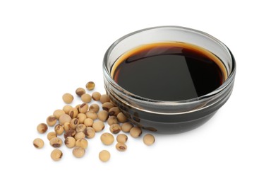 Tasty soy sauce in bowl and soybeans isolated on white