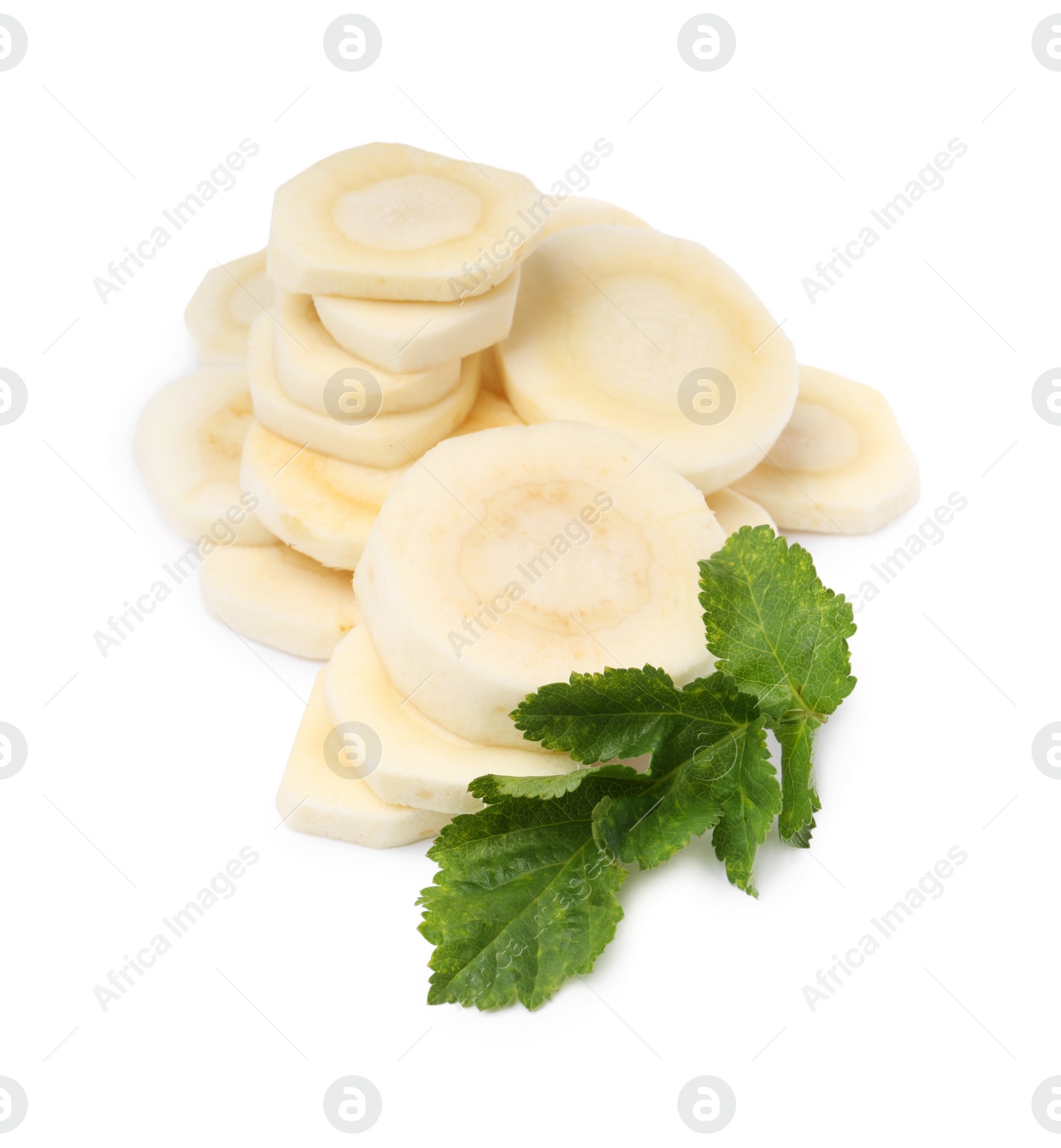 Photo of Cut fresh ripe parsnip with leaves on white background