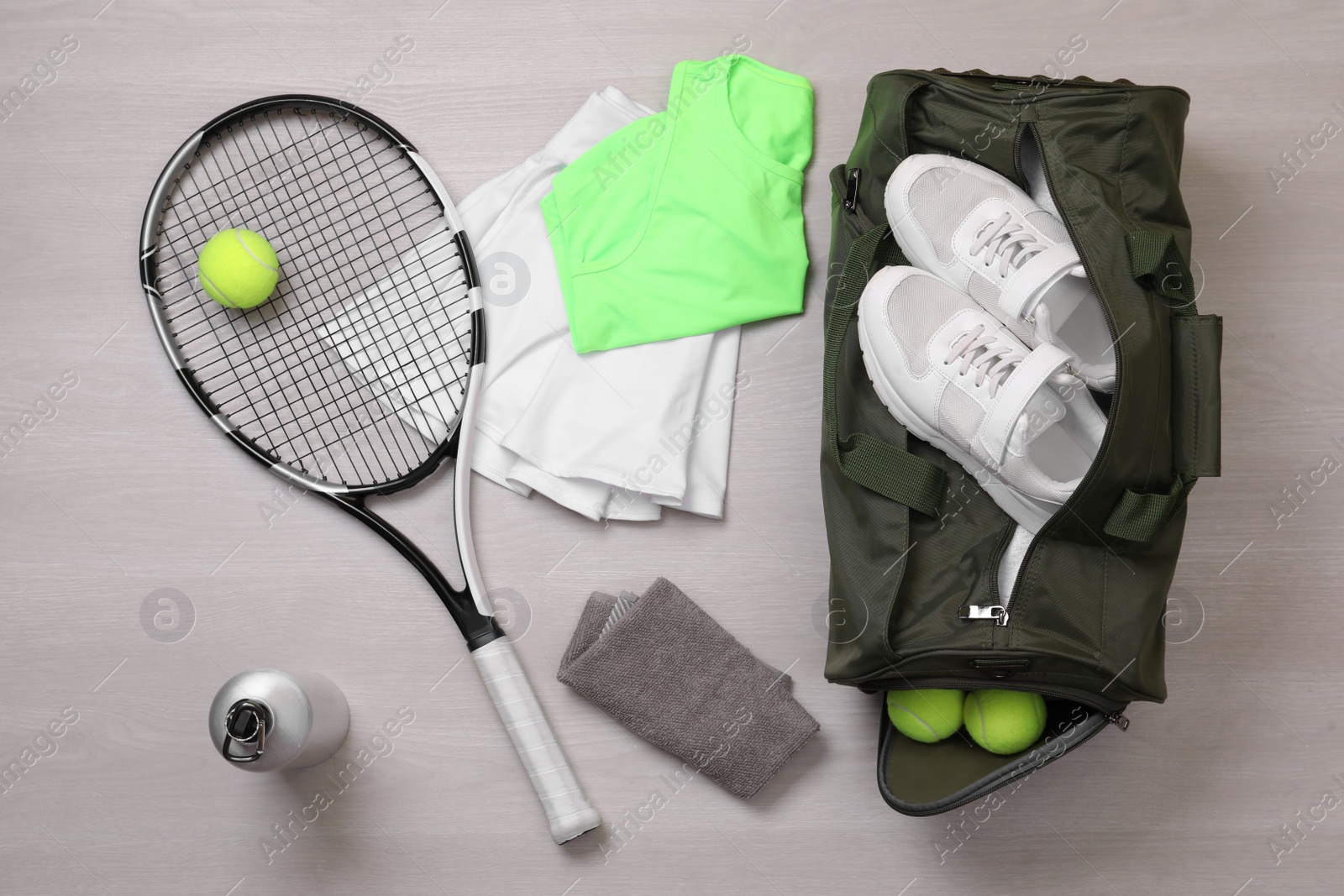 Photo of Sports bag and tennis equipment on wooden background, flat lay