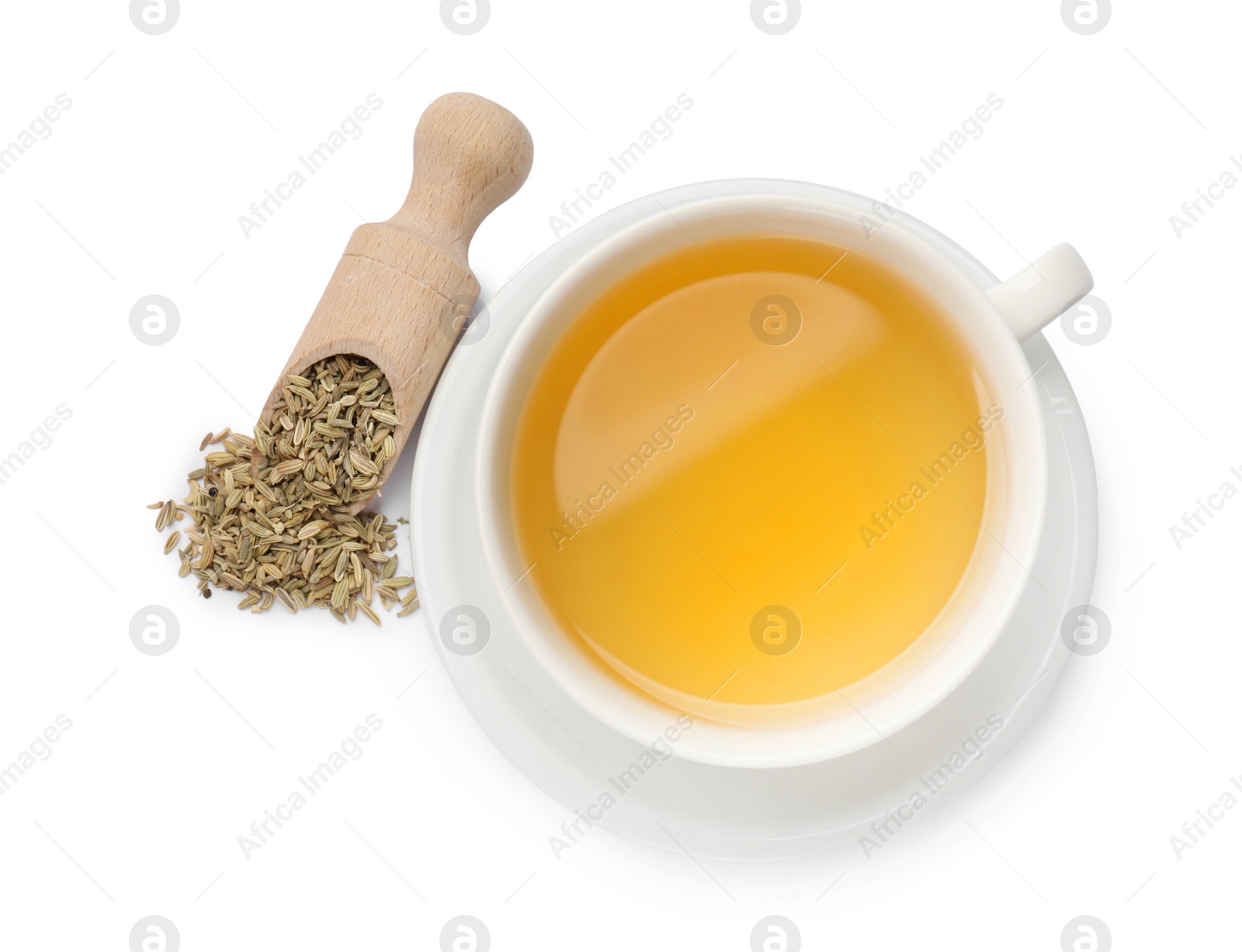 Photo of Aromatic fennel tea in cup, seeds and scoop isolated on white, top view