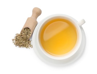 Photo of Aromatic fennel tea in cup, seeds and scoop isolated on white, top view