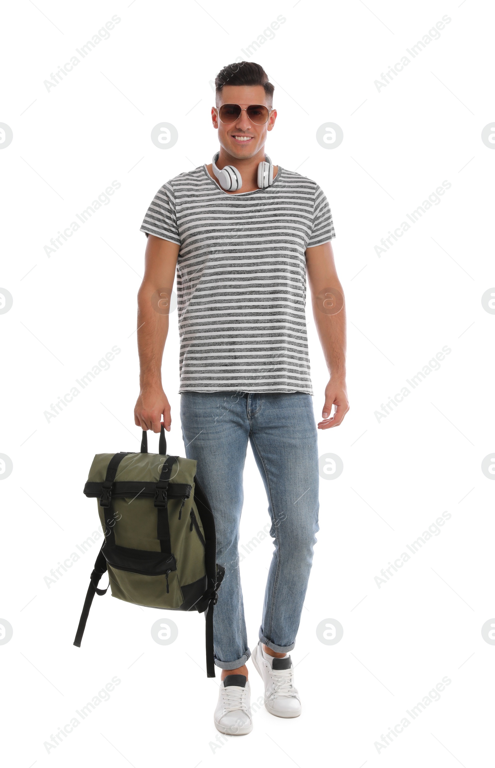 Photo of Man with backpack and headphones on white background. Summer travel