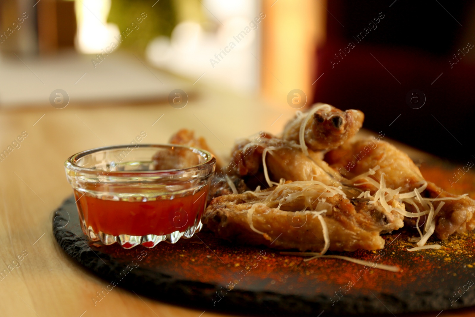 Photo of Tasty BBQ wings served on table in cafe