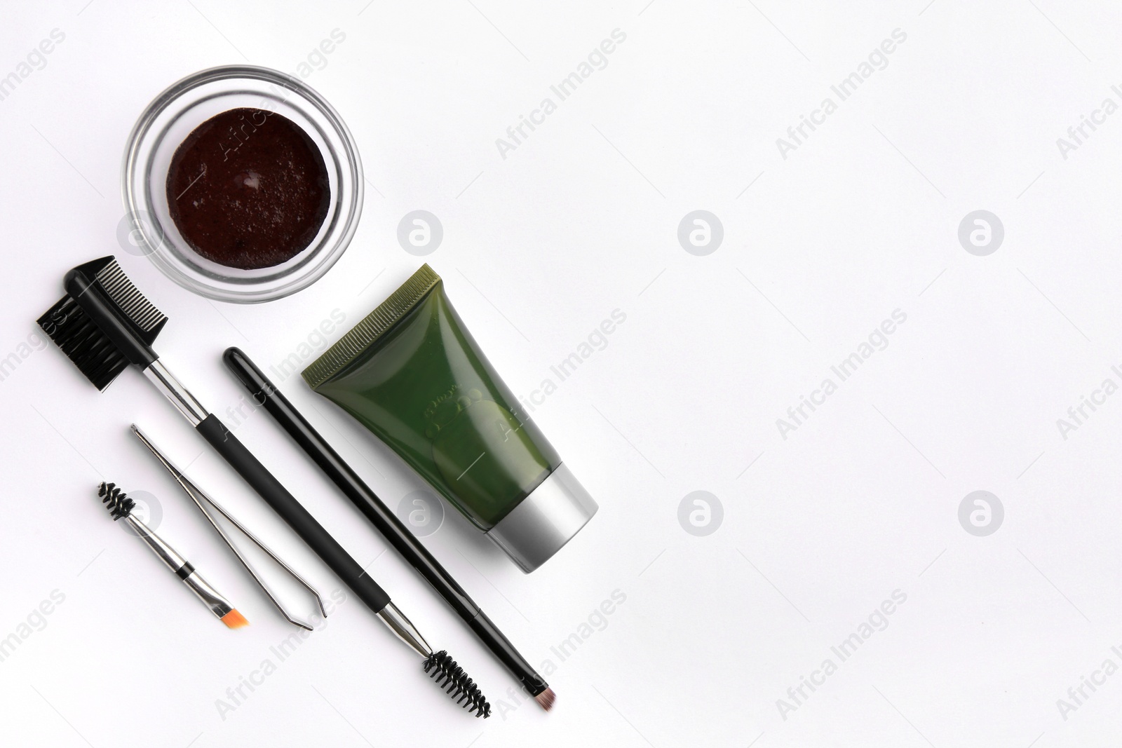 Photo of Flat lay composition with eyebrow henna, professional tools and cosmetic product on white background, space for text