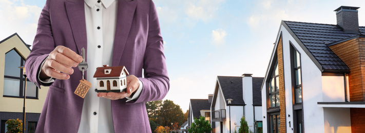 Image of Real estate agent with model against modern houses, space for text. Banner design, closeup 