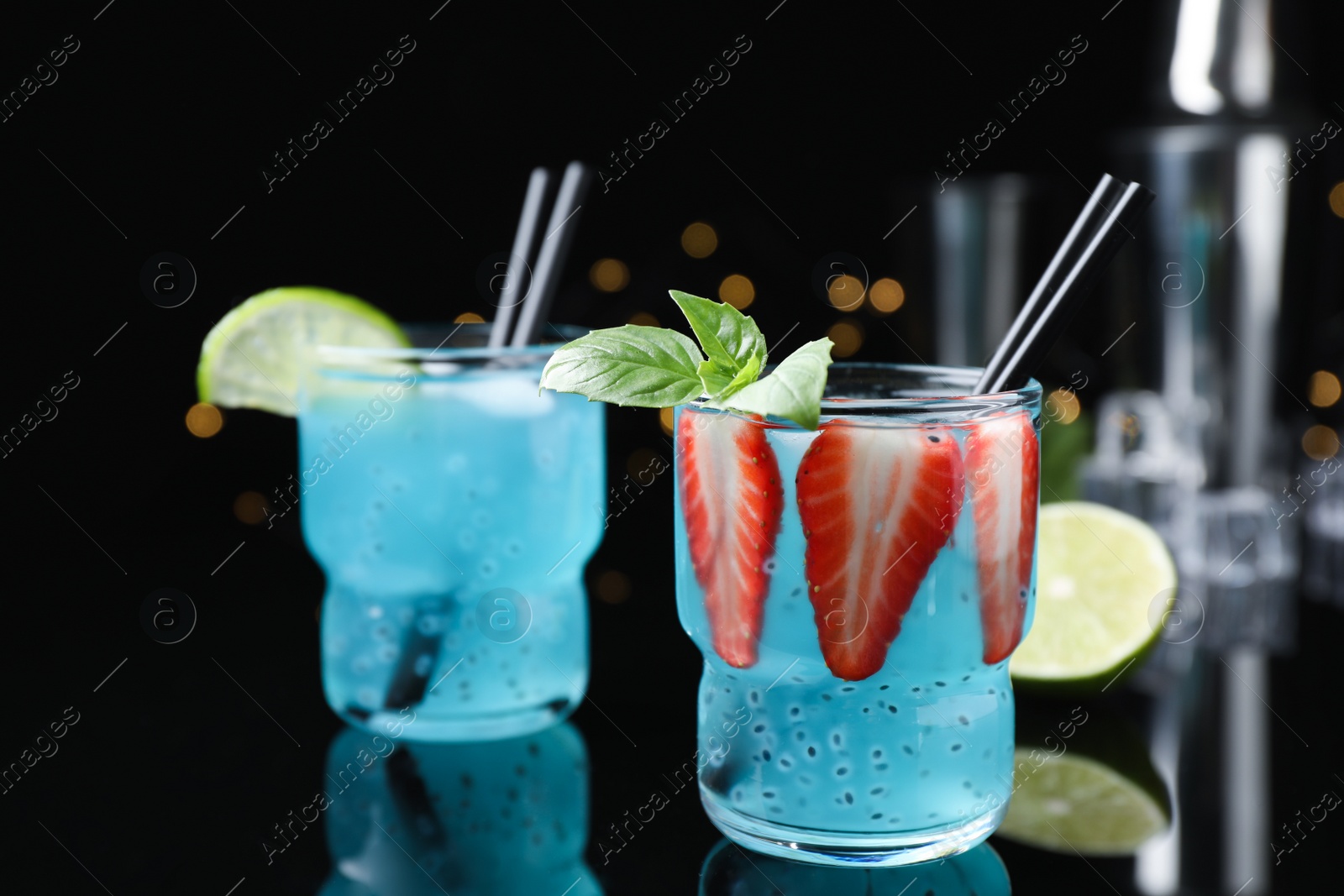 Photo of Cool light blue drinks on black table