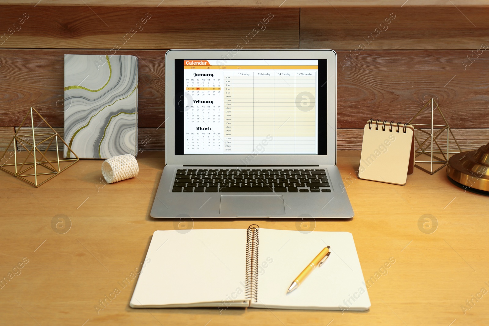 Photo of Modern laptop with calendar on screen in office