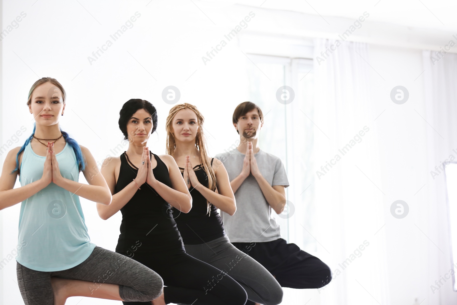 Photo of Group of people practicing yoga indoors