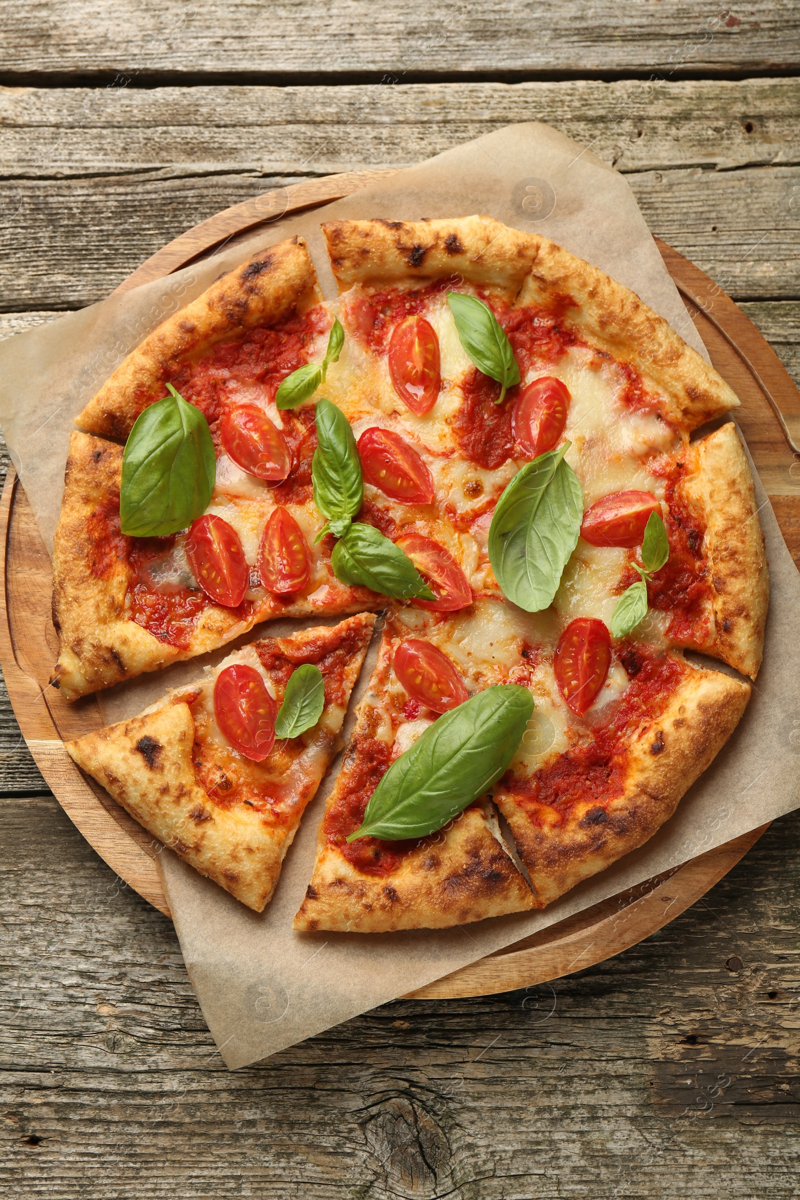 Photo of Delicious Margherita pizza on wooden table, top view