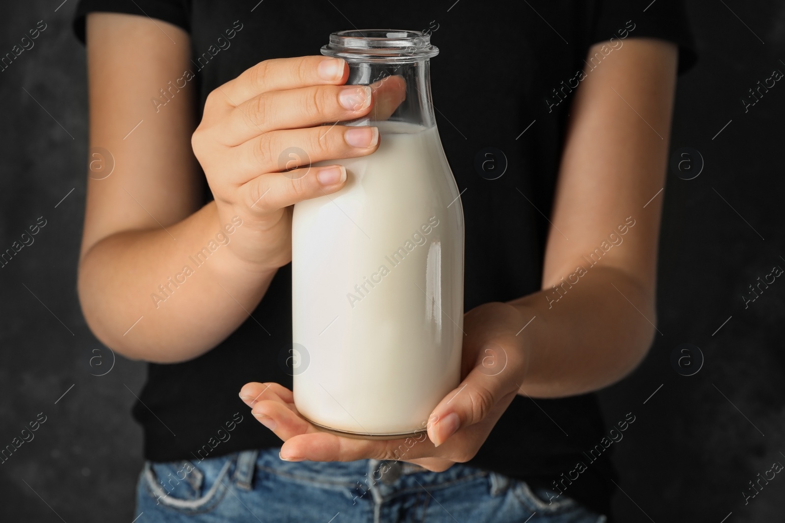 Photo of Woman holding bottle of hemp milk, closeup