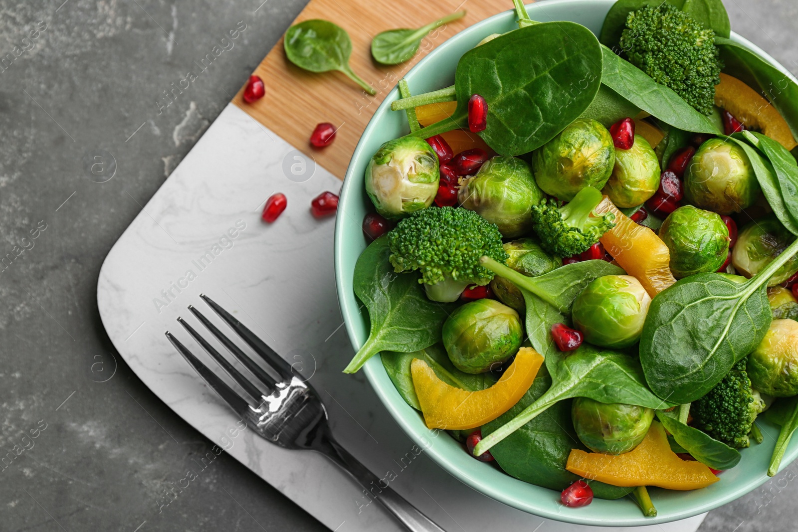 Photo of Tasty salad with Brussels sprouts served on grey table, top view