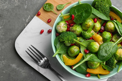 Photo of Tasty salad with Brussels sprouts served on grey table, top view