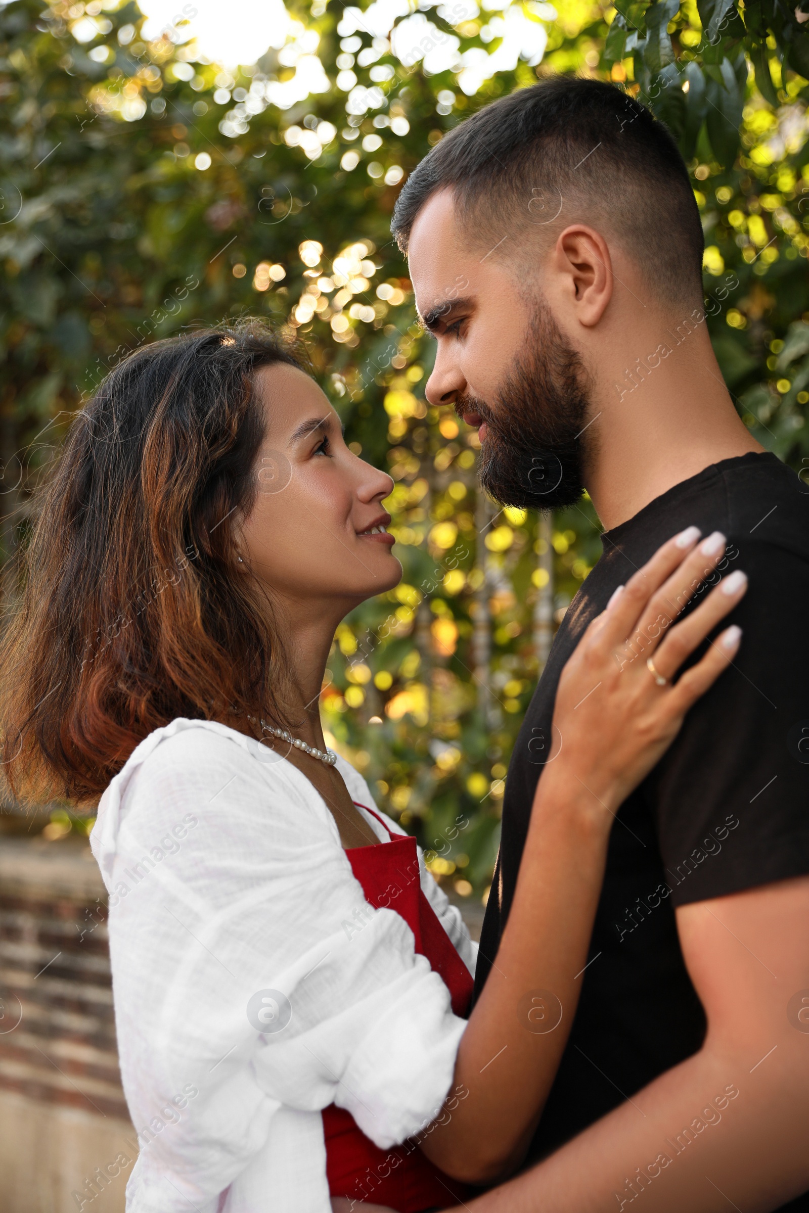 Photo of Happy young couple hugging on city street