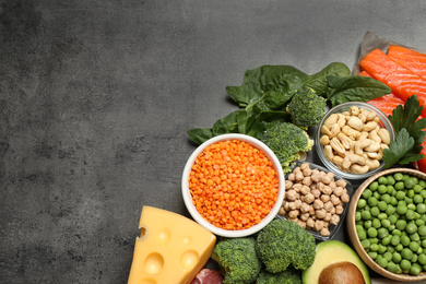 Products rich in protein on grey table, flat lay. Space for text