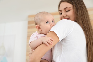 Photo of Mother holding her adorable baby at home