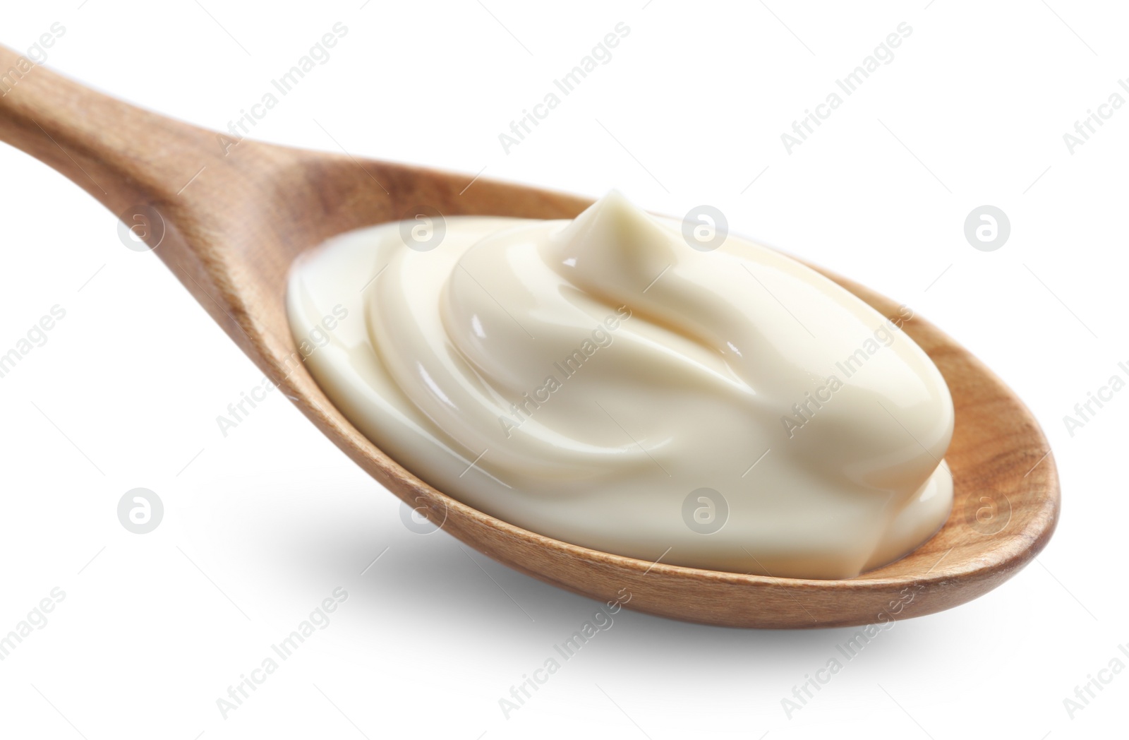 Photo of Natural yogurt in wooden spoon isolated on white