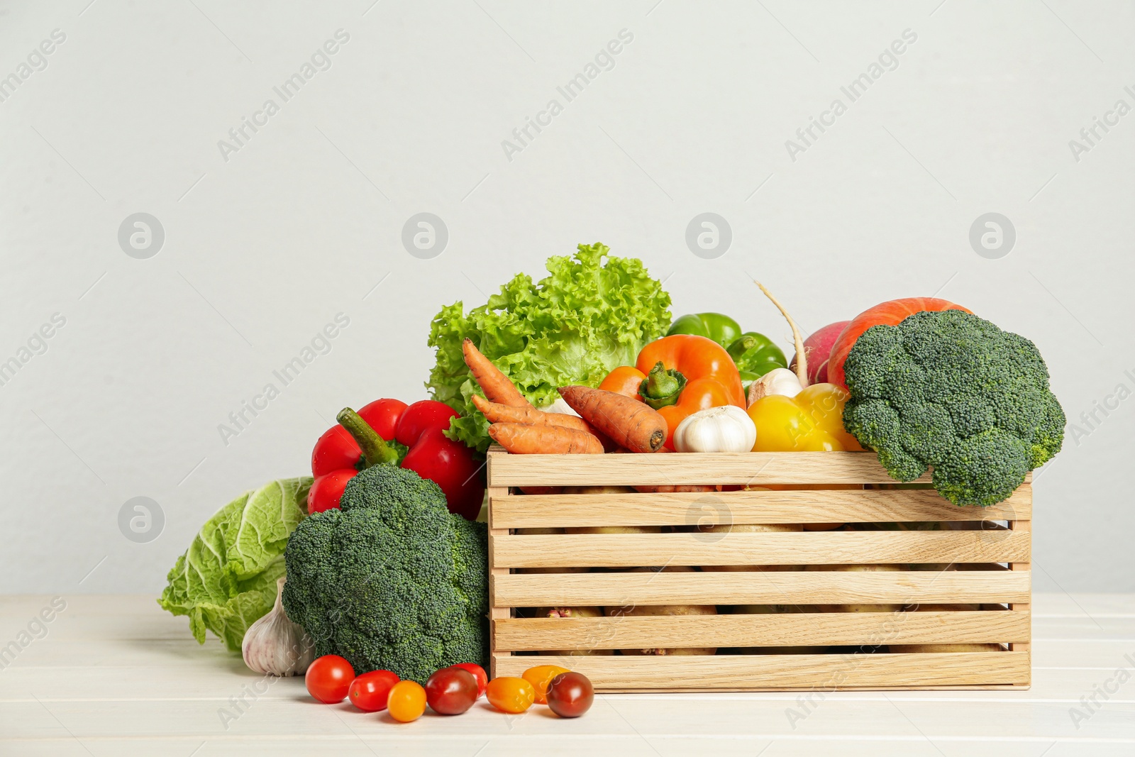 Photo of Assortment of fresh vegetables on white wooden table