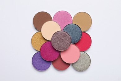 Photo of Beautiful eye shadow refill pans on white background, flat lay