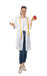 Nutritionist with glass of water and grapefruit on white background