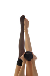 Photo of Young woman putting on stocking against white background, closeup