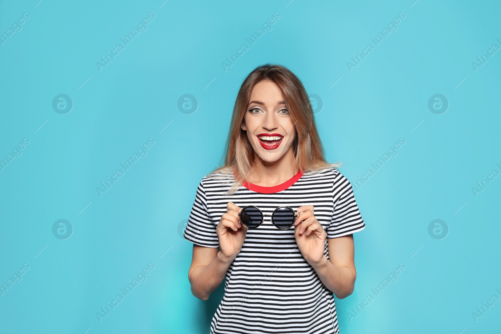 Photo of Beautiful young woman with healthy long blonde hair on color background