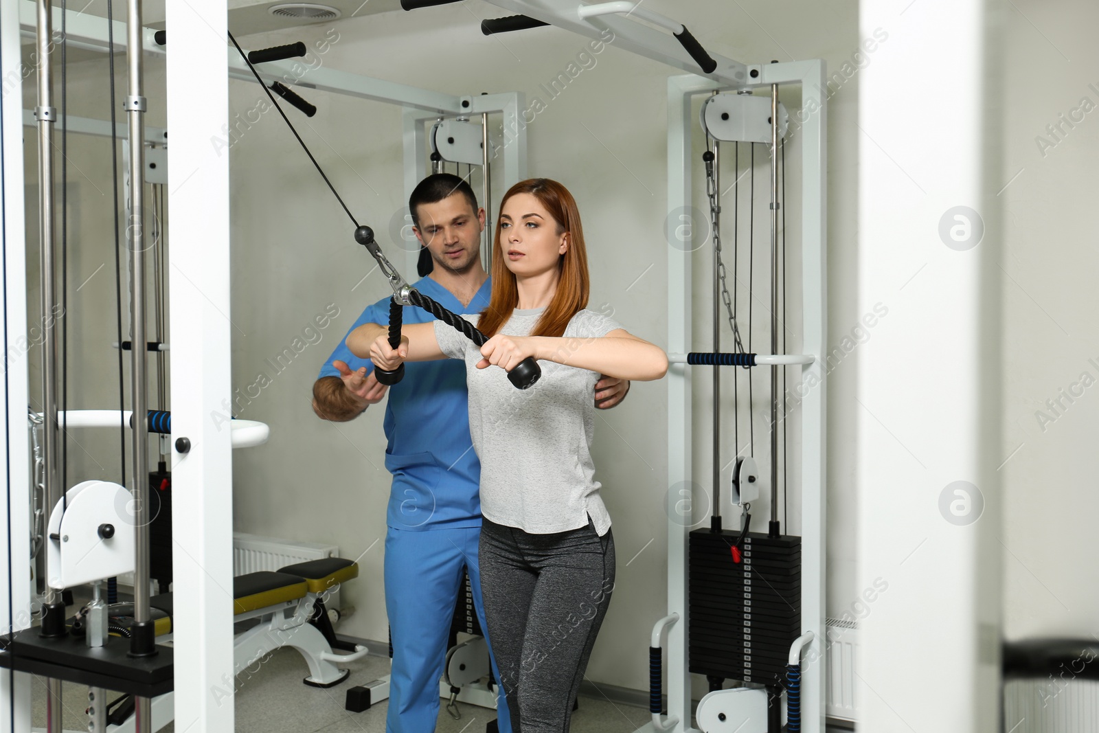 Photo of Patient exercising under physiotherapist supervision in rehabilitation center