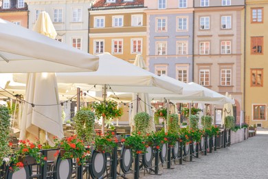 Photo of Cafe with outdoor terrace, umbrellas and beautiful furniture
