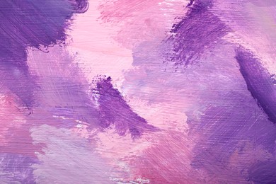 Photo of Beautiful strokes of pink and violet oil paints as background, closeup