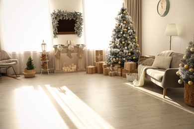 Photo of Stylish Christmas interior with beautiful decorated tree and fireplace