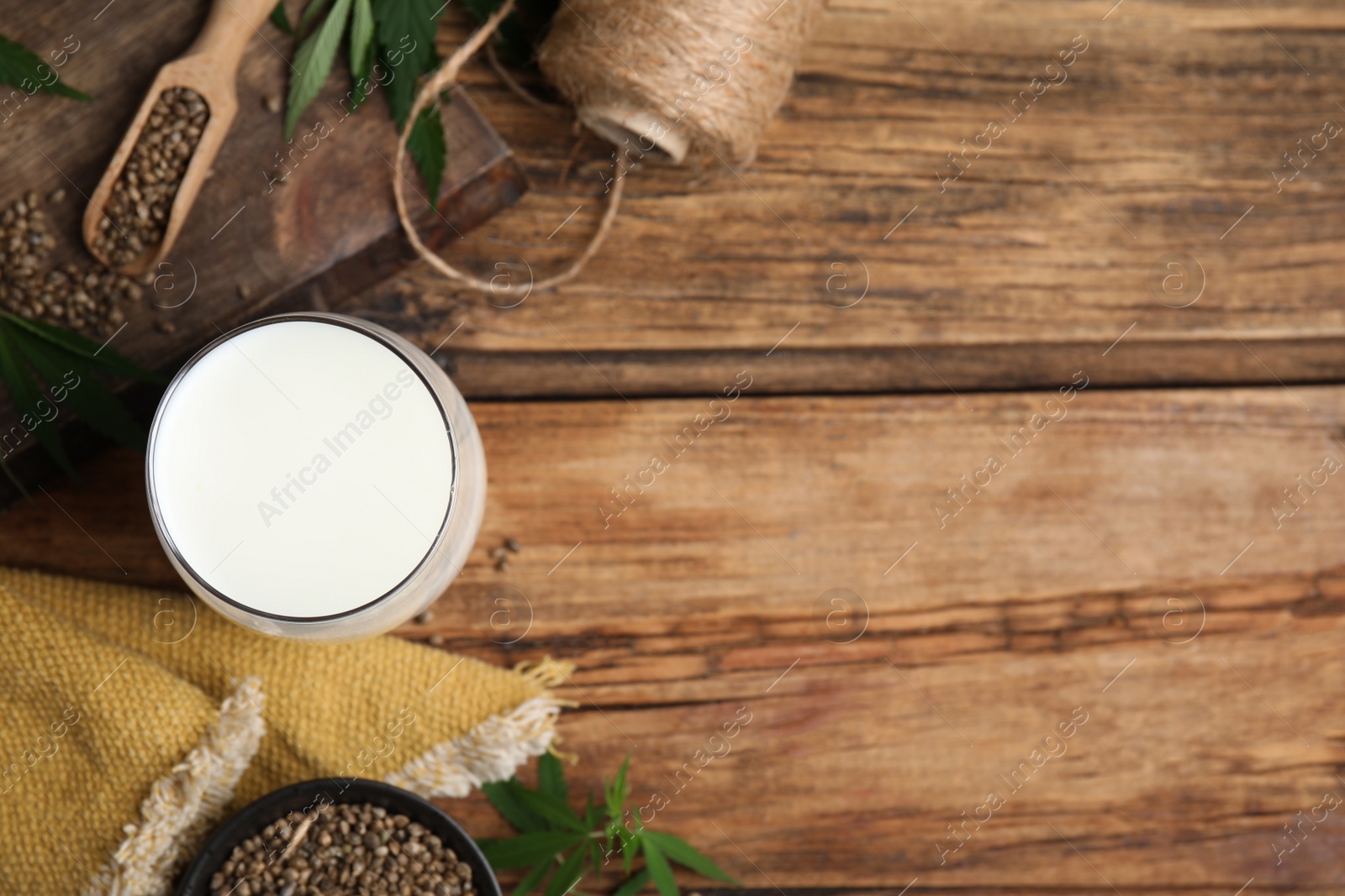 Photo of Flat lay composition with fresh hemp milk on wooden table. Space for text