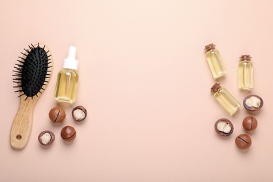 Photo of Delicious organic Macadamia nuts, cosmetic oil and brush on beige background, flat lay. Space for text