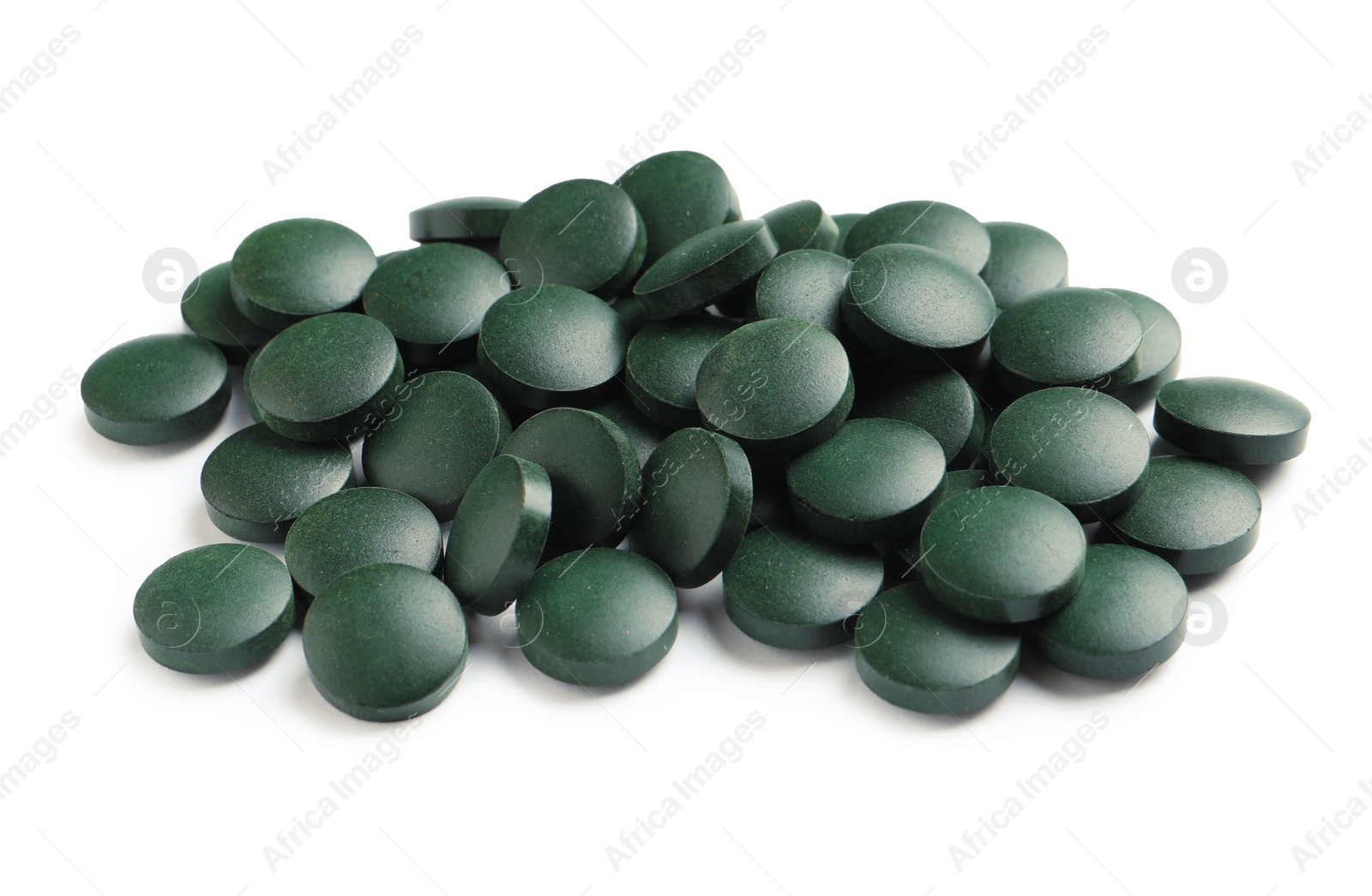 Photo of Heap of spirulina tablets on white background