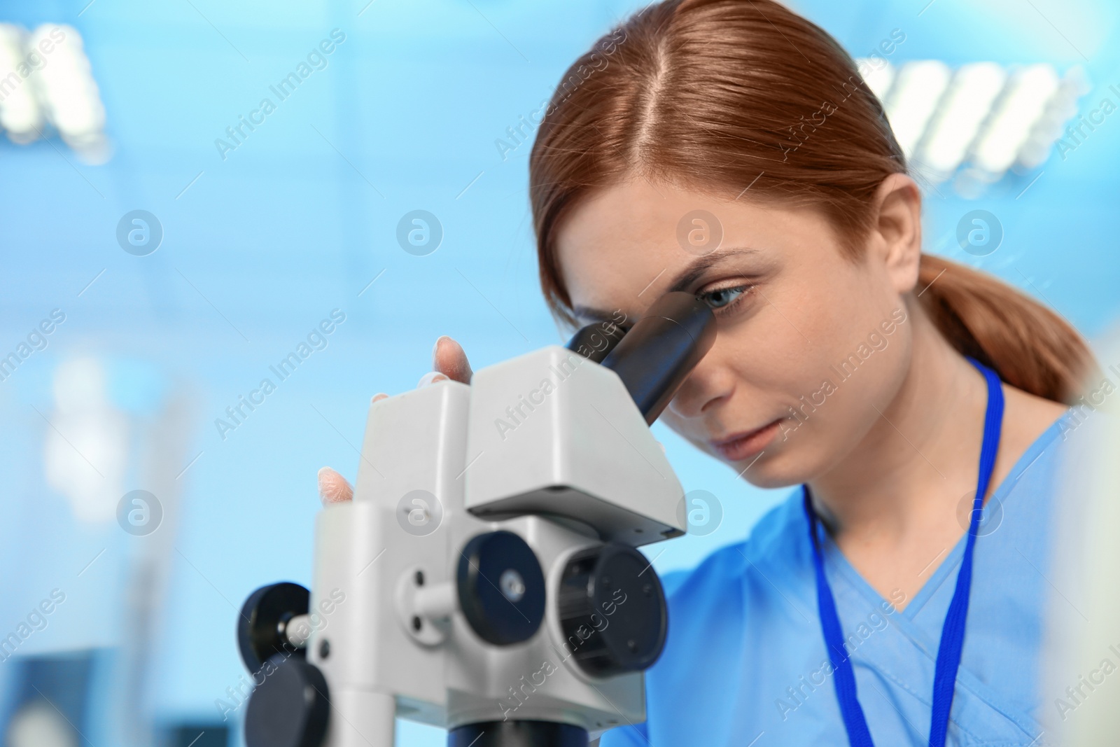 Photo of Female scientist using microscope in chemistry laboratory, space for text