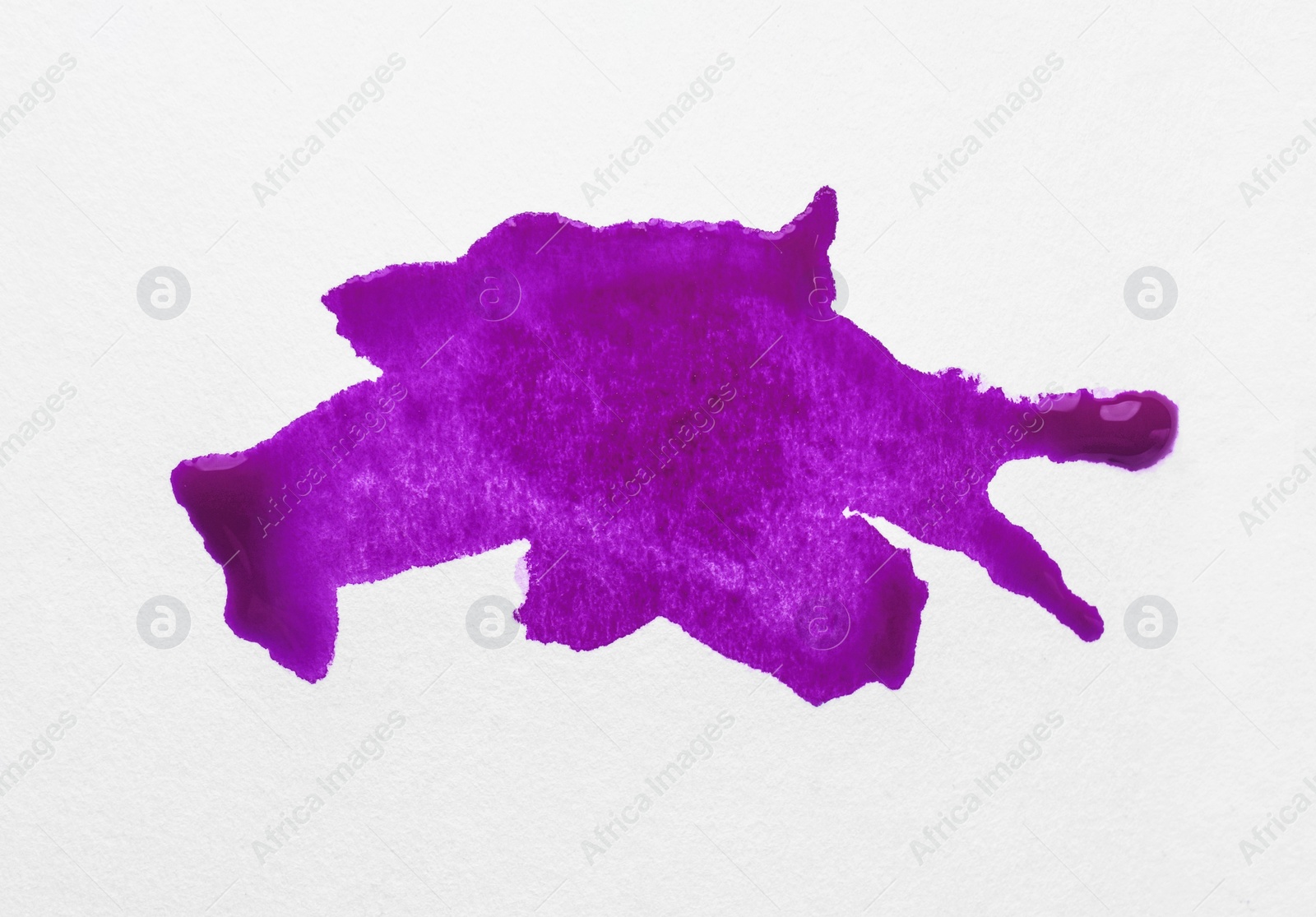 Photo of Blot of purple ink on white background, top view