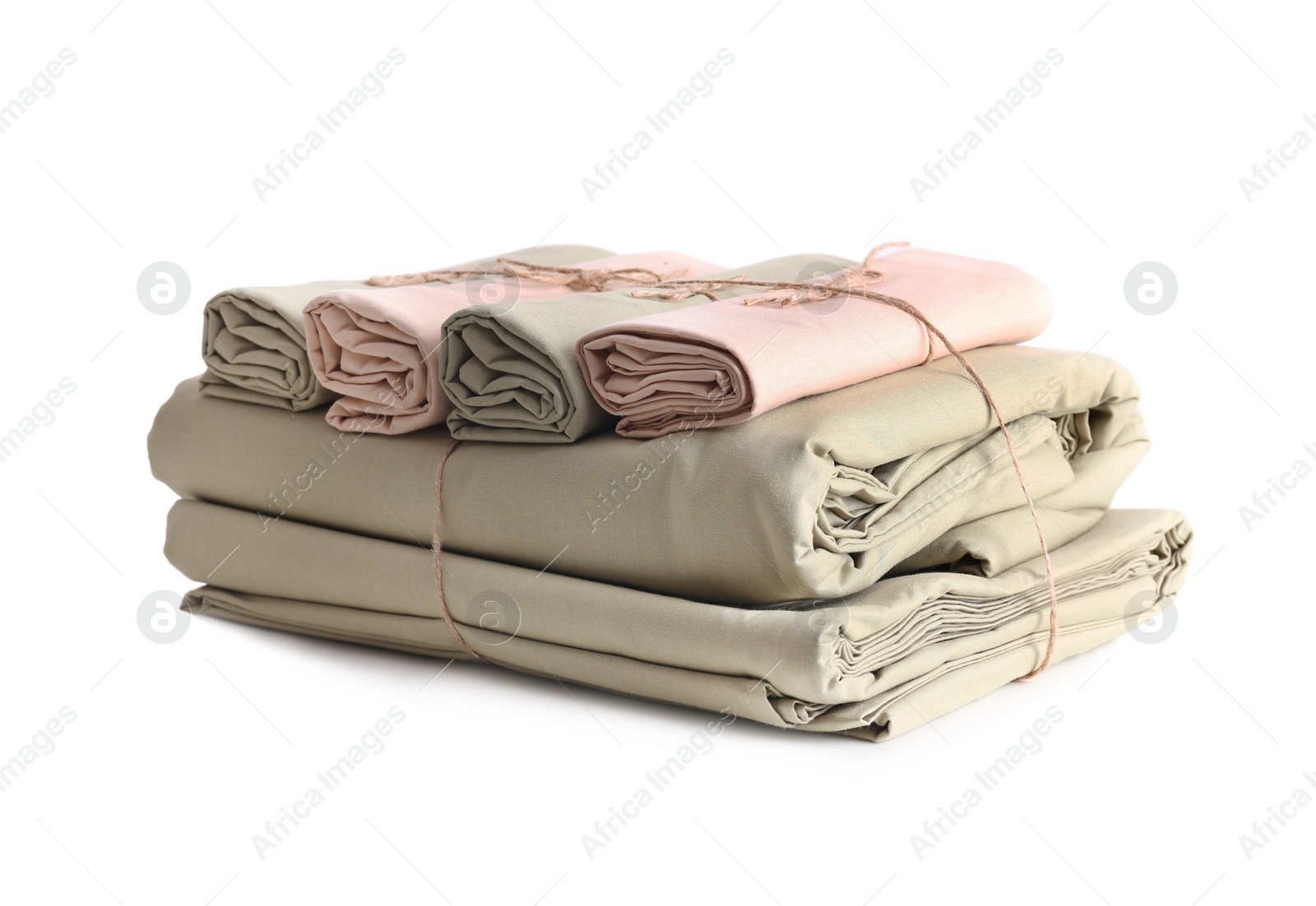 Photo of Stack of clean bed sheets tied with rope isolated on white