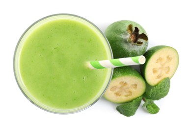 Fresh feijoa smoothie in glass and fresh fruits on white background, top view