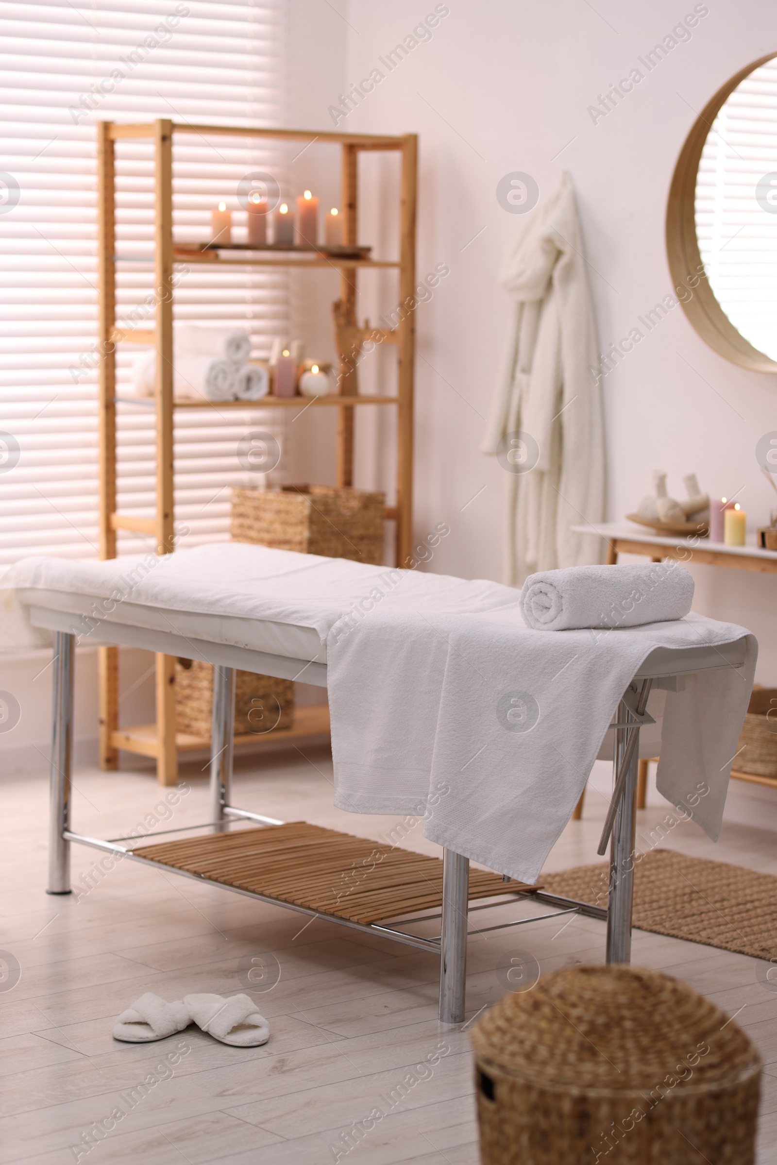 Photo of Comfortable massage table with clean towels in spa center