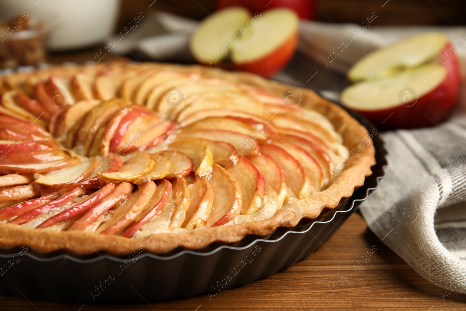 Photo of Delicious homemade apple tart on wooden table, closeup