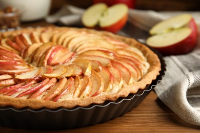 Photo of Delicious homemade apple tart on wooden table, closeup