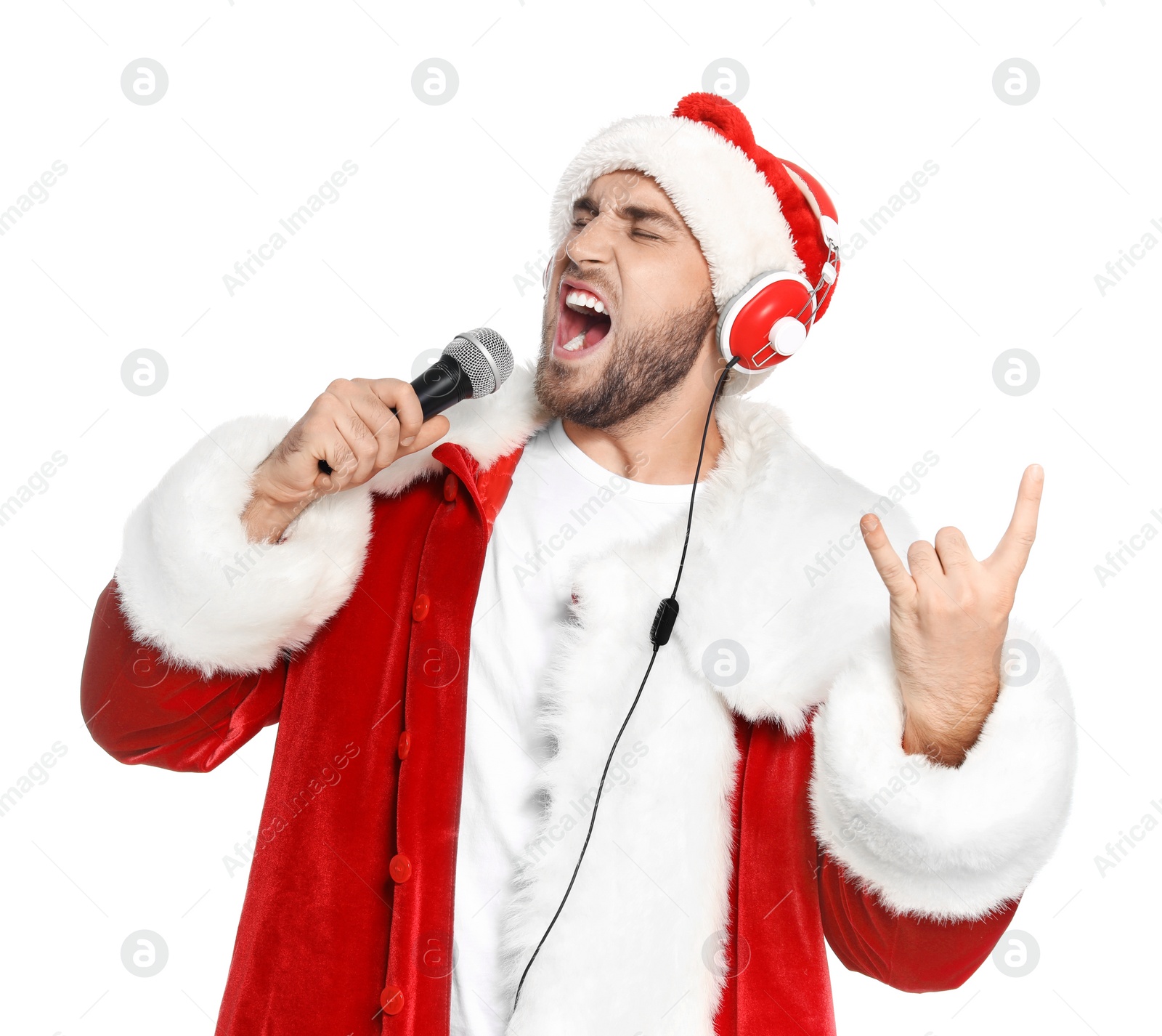 Photo of Young man in Santa costume singing into microphone on white background. Christmas music